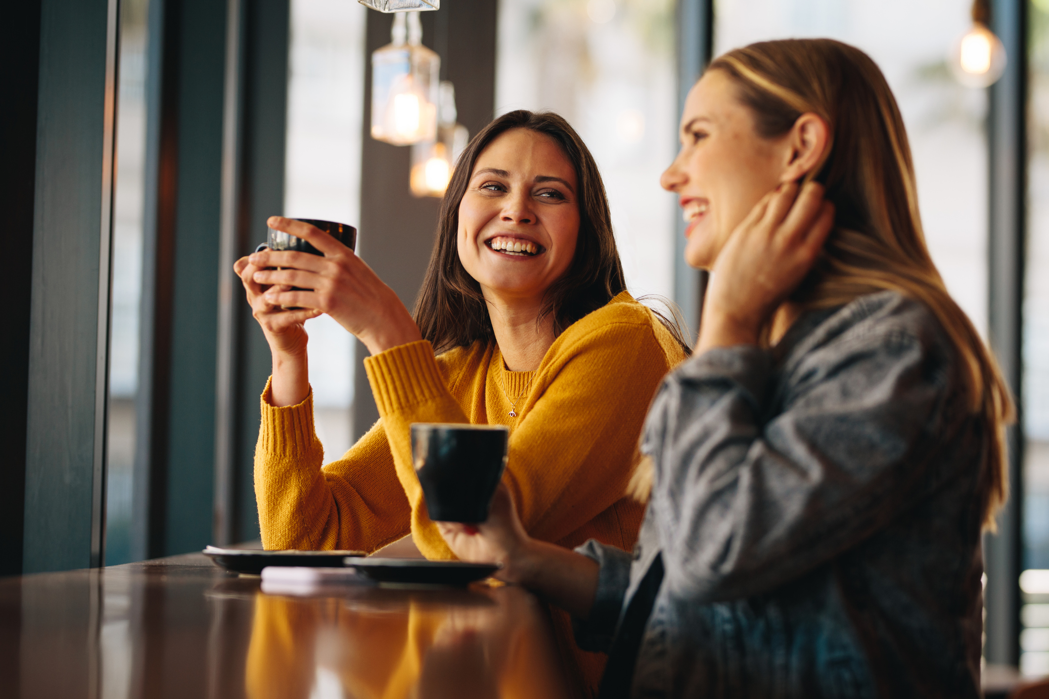 Two ladies in café drinking coffee, it’s good to talk